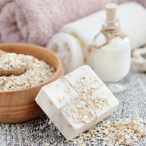 Stock photo of natural Honey Oatmeal Soap with towels and real oatmeal in a bowel