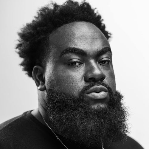 Black and white portrait of a man with a beard and short hair.