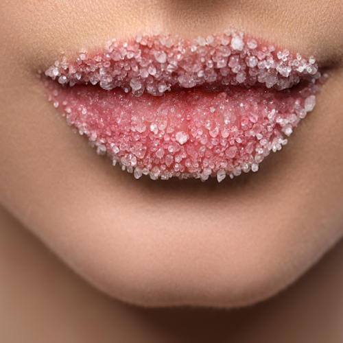 Close-up of lips with a sugary peach scrub on model